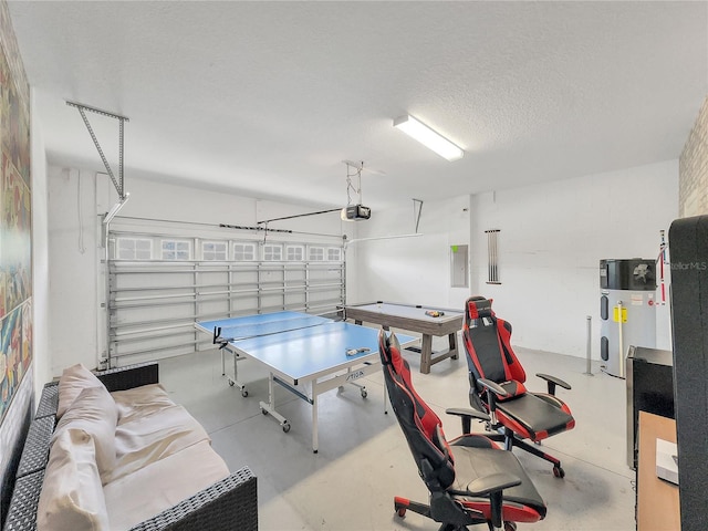 game room featuring a textured ceiling, hybrid water heater, and electric panel