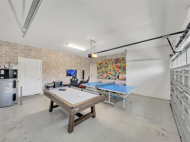 game room featuring heat pump water heater and brick wall