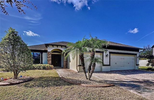 view of front of home with a garage and a front lawn