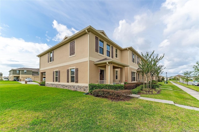 view of front of home with a garage, a front lawn, and covered porch