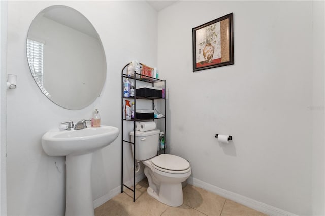 bathroom featuring sink, toilet, and tile patterned floors