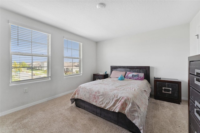 carpeted bedroom featuring a textured ceiling