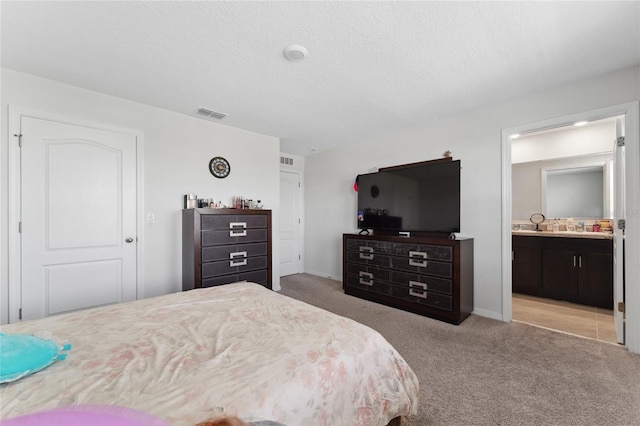 bedroom with a textured ceiling, light carpet, and a closet