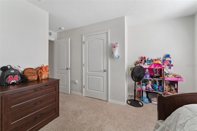 carpeted bedroom featuring a textured ceiling