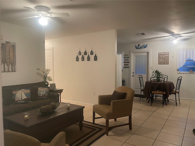 tiled living room with ceiling fan