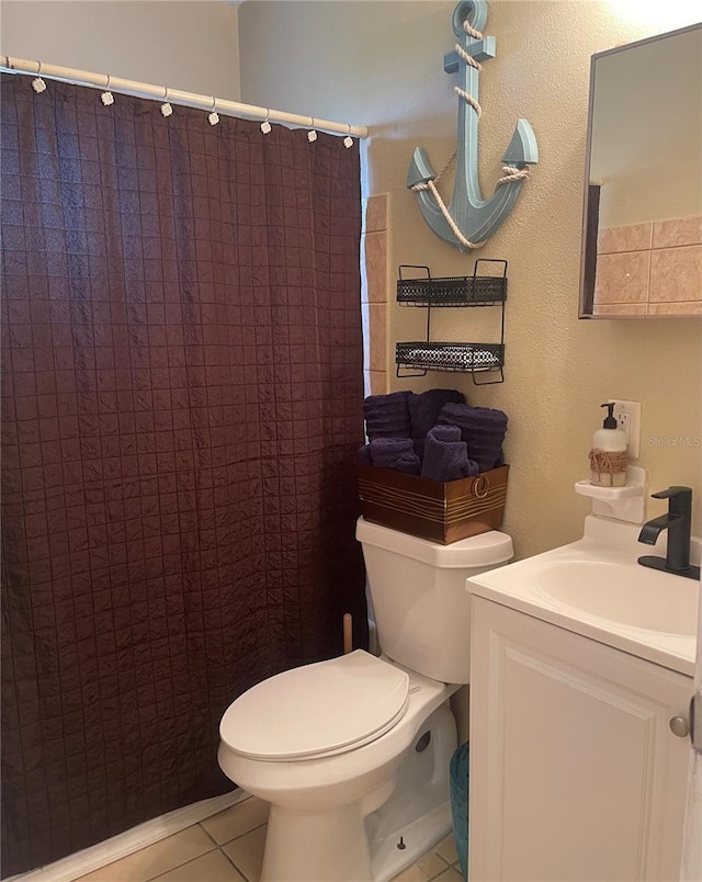 bathroom with tile patterned flooring, vanity, toilet, and a shower with curtain