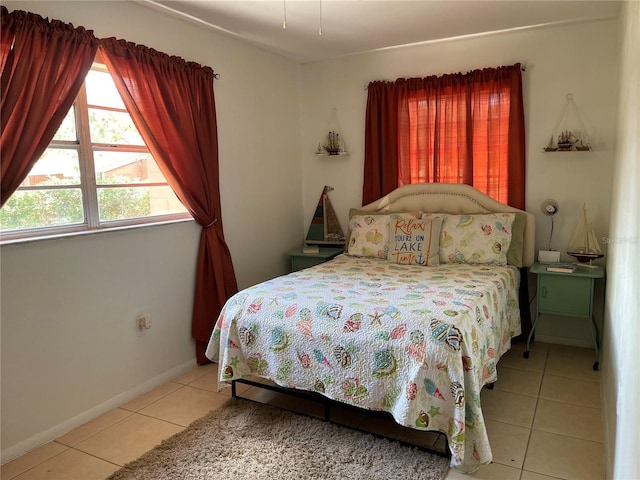 tiled bedroom with multiple windows