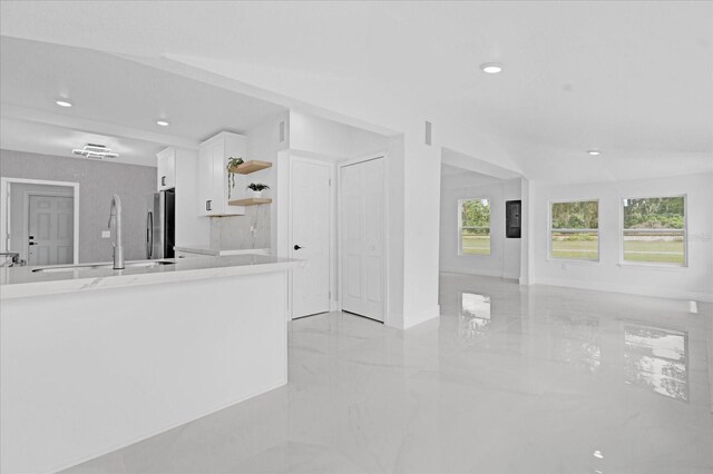 unfurnished living room with sink