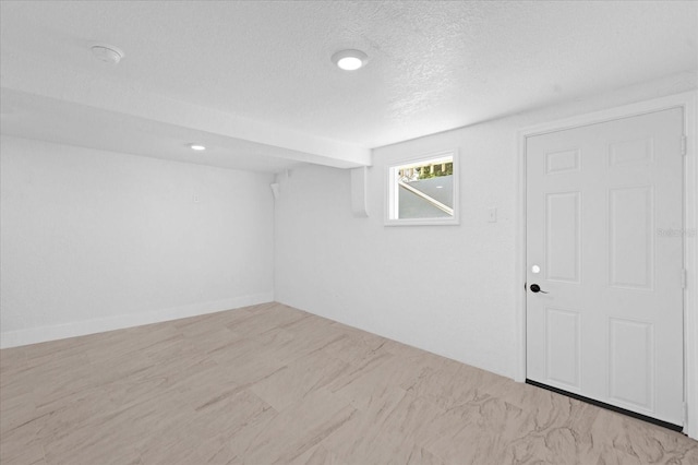 unfurnished room featuring a textured ceiling