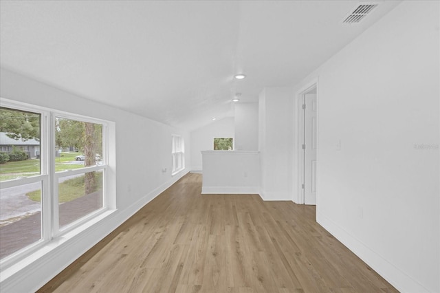 unfurnished living room featuring lofted ceiling and light hardwood / wood-style flooring