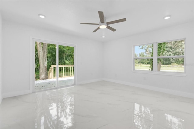 spare room with plenty of natural light and ceiling fan