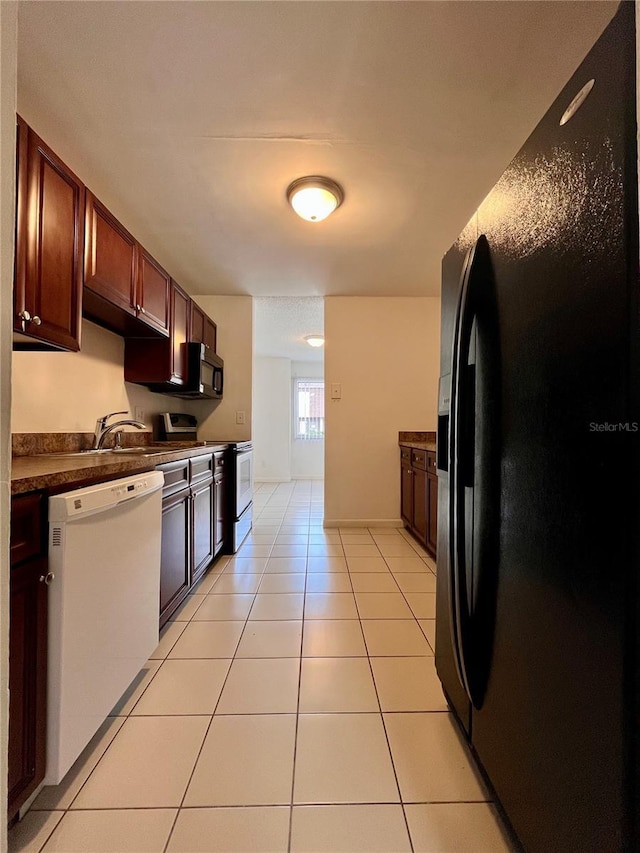 kitchen with light tile patterned floors, dishwasher, dark countertops, black fridge with ice dispenser, and electric stove
