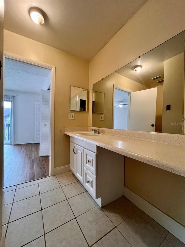 bathroom featuring ceiling fan, hardwood / wood-style flooring, and vanity