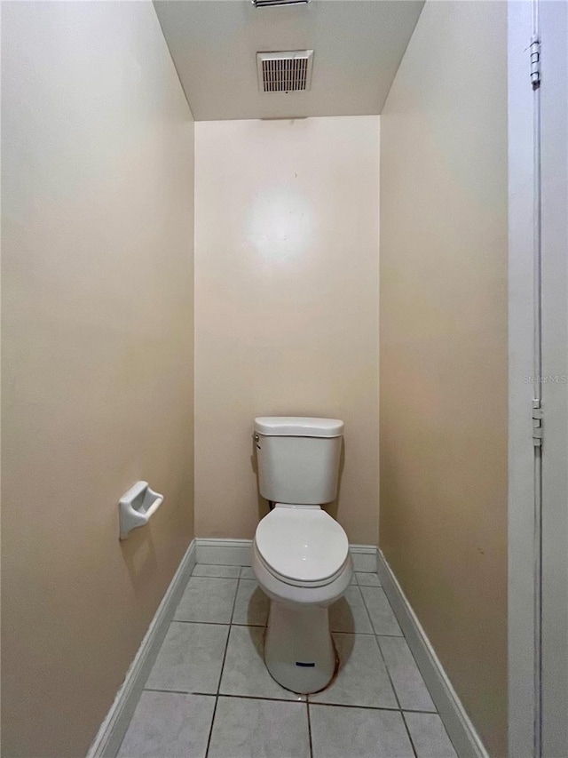 bathroom with tile patterned floors, visible vents, baseboards, and toilet