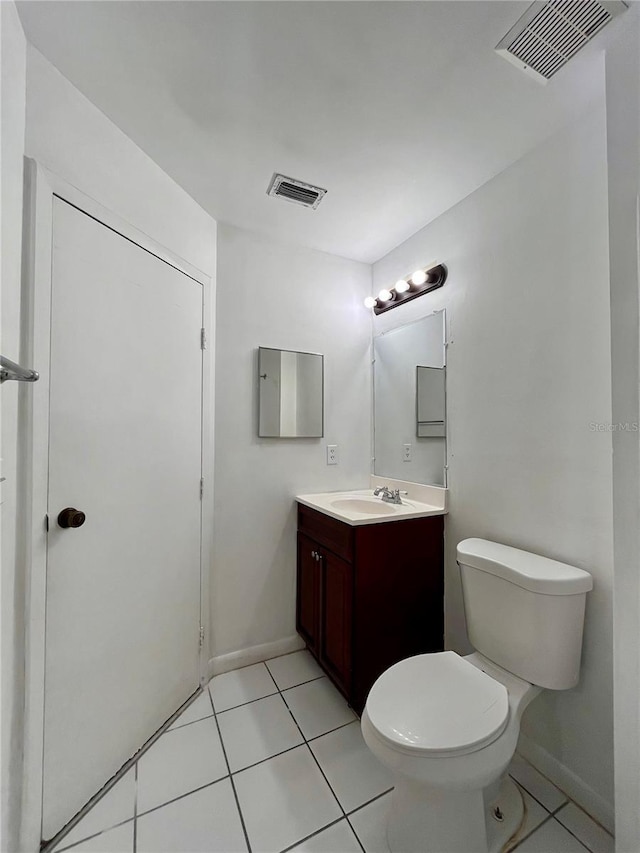 bathroom with toilet, tile patterned floors, vanity, and visible vents