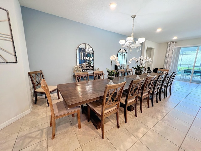 tiled dining space featuring an inviting chandelier