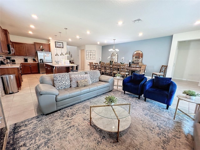 tiled living room featuring a chandelier