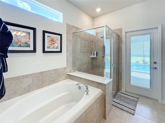 bathroom with tile patterned floors, a wealth of natural light, and plus walk in shower