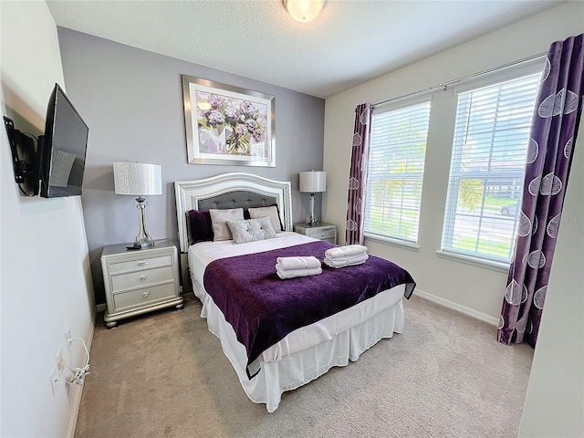 carpeted bedroom featuring a textured ceiling