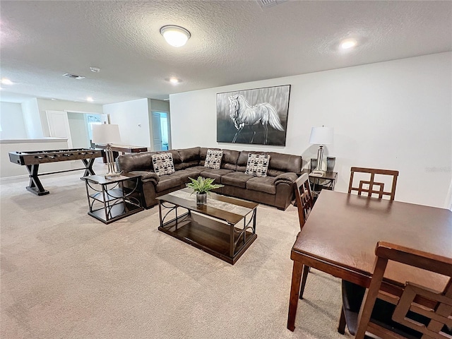 living room with light carpet and a textured ceiling