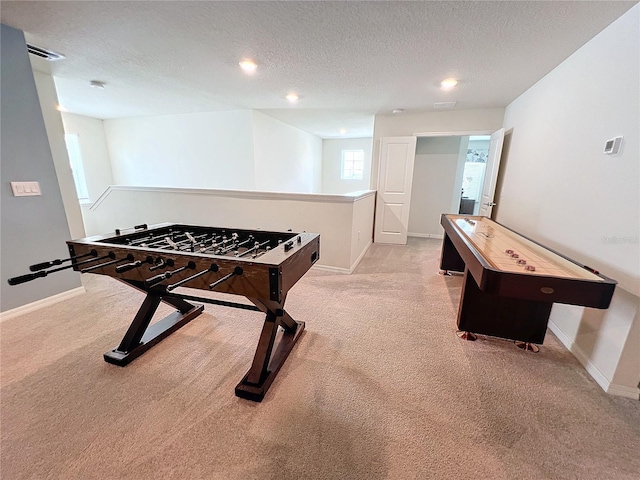 playroom with light carpet and a textured ceiling