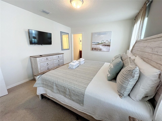 carpeted bedroom featuring a textured ceiling