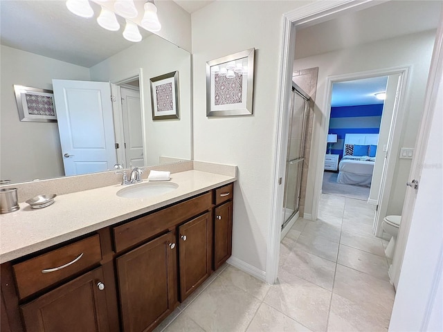 bathroom featuring vanity, tile patterned flooring, toilet, and walk in shower