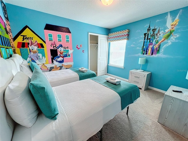 bedroom featuring a closet, a textured ceiling, and carpet flooring