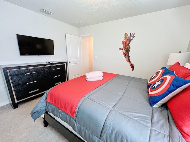 carpeted bedroom with a textured ceiling