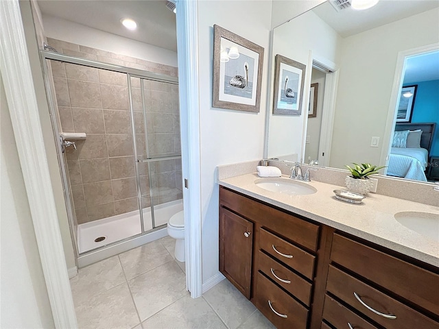 bathroom with vanity, toilet, tile patterned floors, and walk in shower