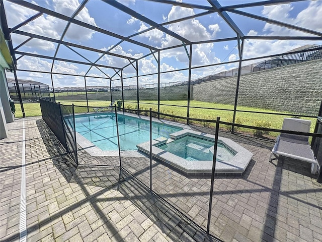 view of pool featuring a patio area, a lanai, and an in ground hot tub