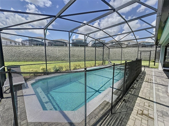 view of pool featuring a patio area and glass enclosure