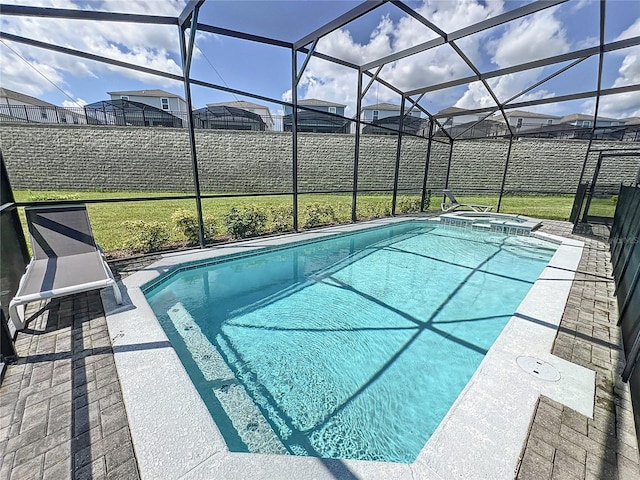 view of swimming pool featuring an in ground hot tub, a patio, and a lanai