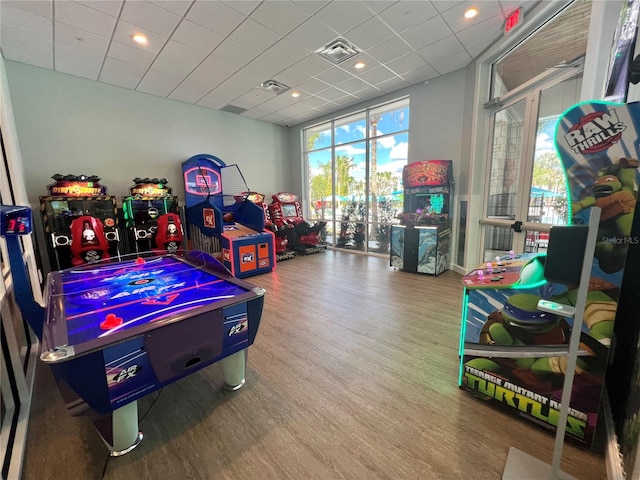 game room featuring a drop ceiling and hardwood / wood-style floors