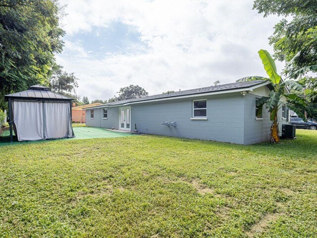 exterior space featuring central AC, a gazebo, and a yard