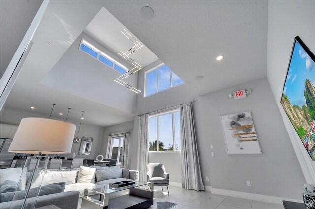 tiled living room featuring a towering ceiling