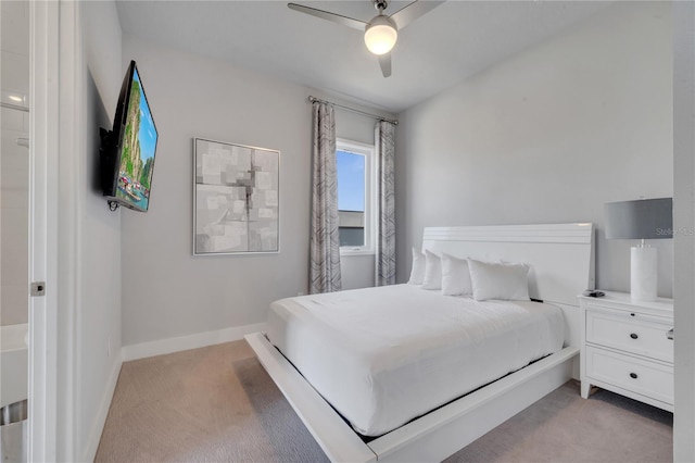 bedroom featuring ceiling fan and light carpet