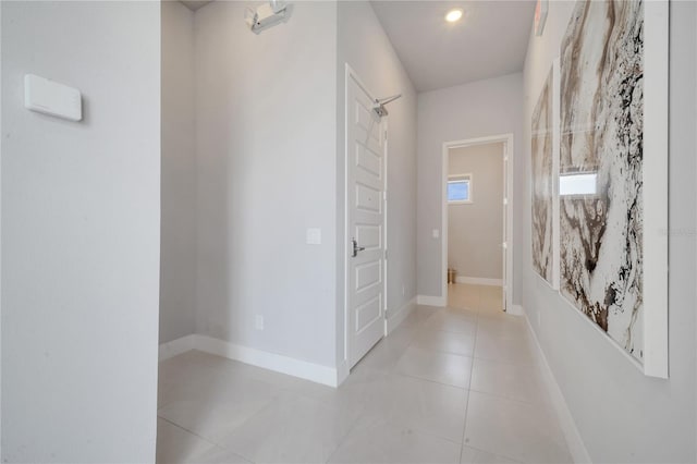 hall with light tile patterned floors