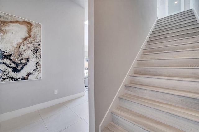 staircase with tile patterned floors