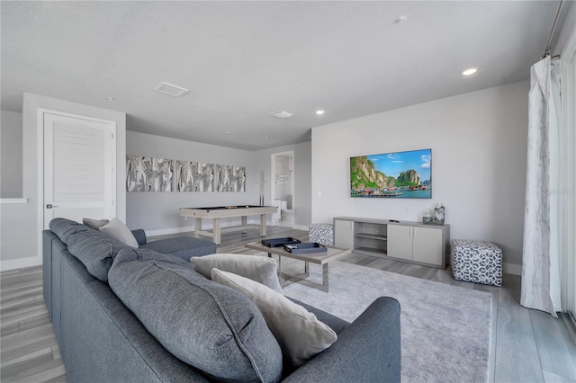 living room with light hardwood / wood-style flooring