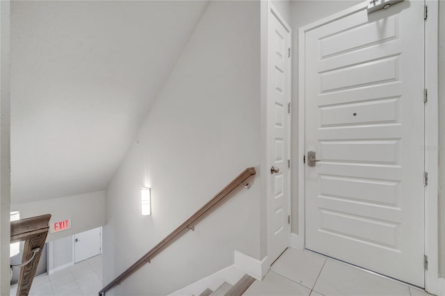 interior space with lofted ceiling and tile patterned flooring