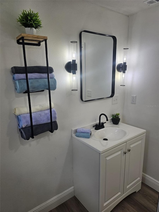 bathroom featuring vanity and hardwood / wood-style floors