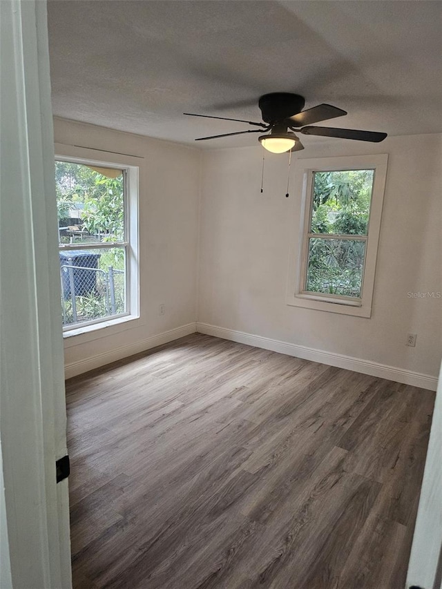 empty room featuring a textured ceiling, hardwood / wood-style floors, and ceiling fan