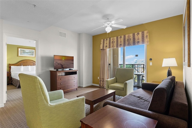 living room with ceiling fan and light colored carpet