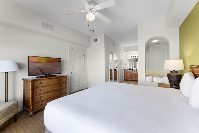 carpeted bedroom featuring ceiling fan and connected bathroom