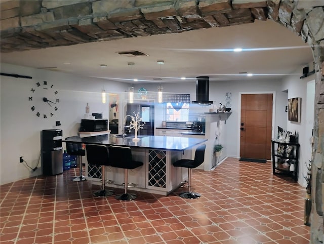 kitchen featuring a kitchen breakfast bar, sink, and extractor fan