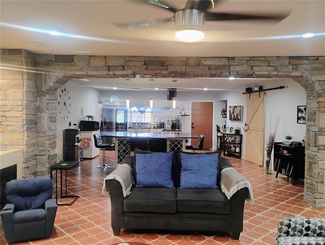 living room with a barn door and sink