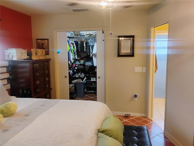 bedroom with tile patterned floors and a closet