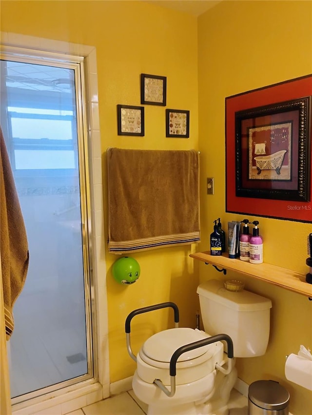 bathroom featuring walk in shower, tile patterned flooring, and toilet