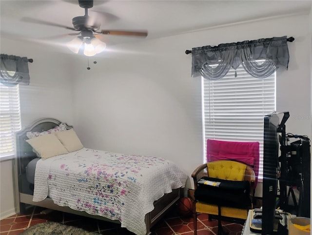 bedroom featuring ceiling fan and dark tile patterned floors